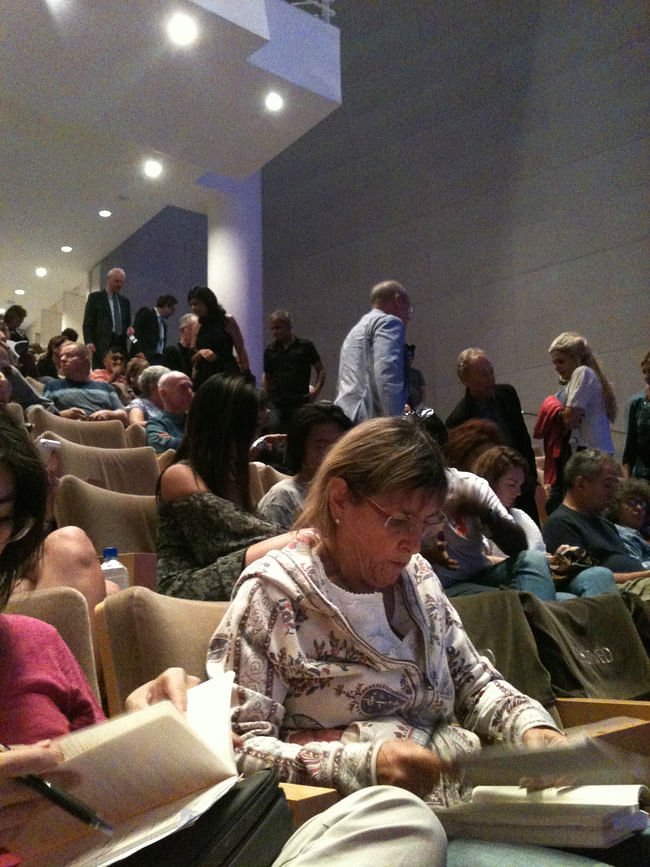 The audience files into the Harold M. Williams auditorium.