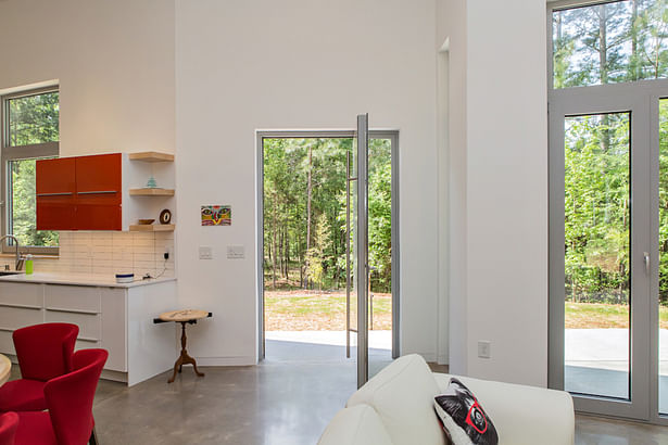 An oversized steel front door that pivots in place is one of many space-saving ideas in this ultra-efficient house.