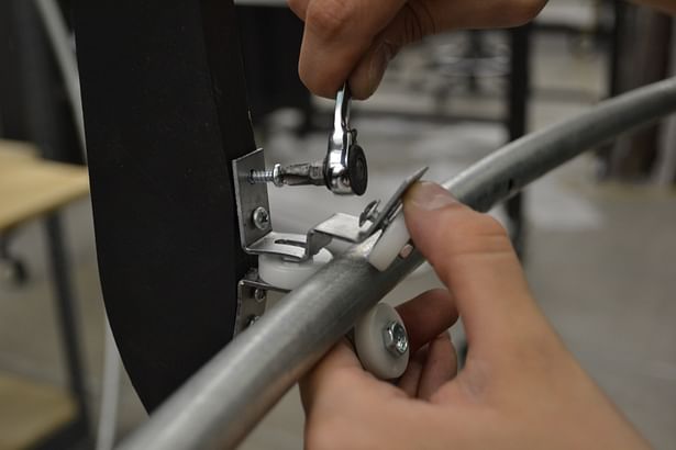 Rolling connector attaching the conduit hoops, representing the sun's path at the solstices or equinox, to the frame of the machine