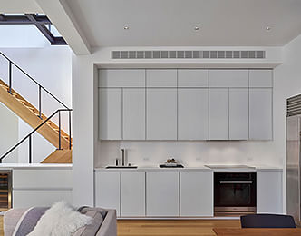 Clean, white finishes combined with natural wood tones help create a warm, light-filled space. 