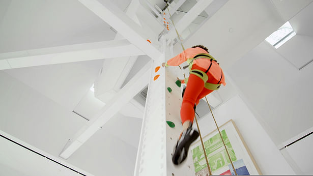 belaying reel and climbing holds at four-story living room column 
