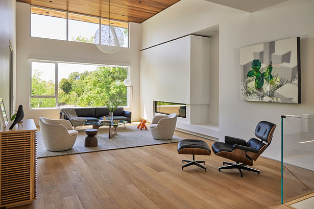 The living room features a wood ceiling and new linear fireplace