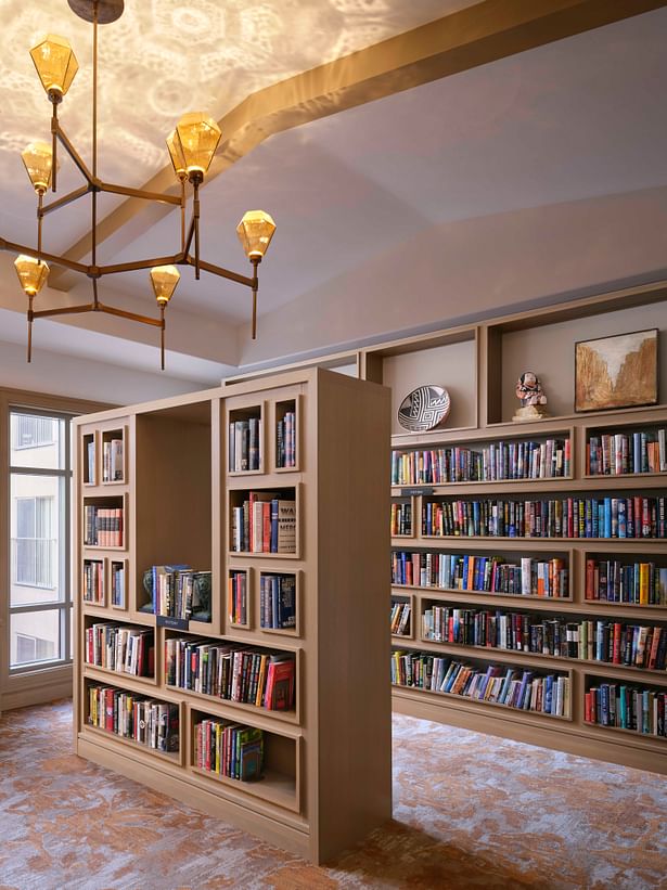 A jewel-like chandelier creates the striking effect of refracted light at the ceiling in the library. (photo by Will Pryce)