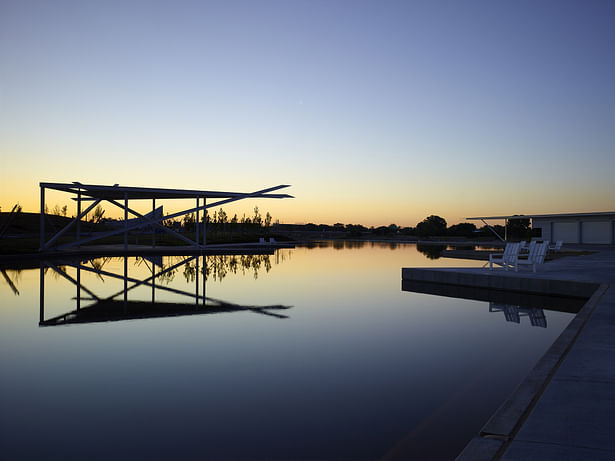 The pavilion at sunrise reflecting in still water before the white water pumps come on