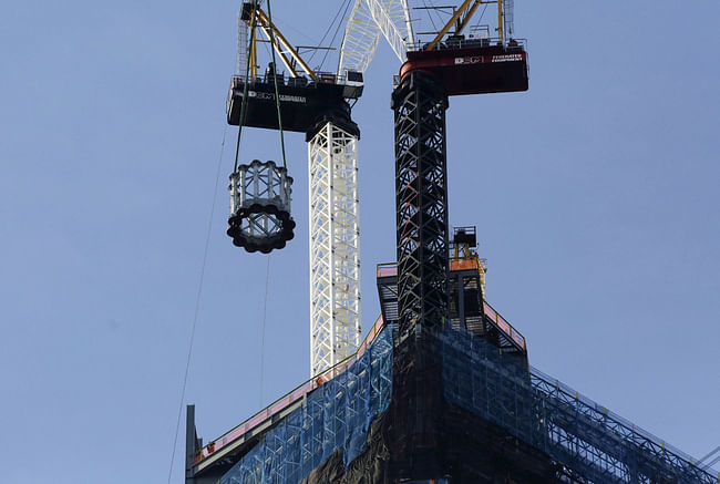 The first section of a 408-foot spire is hoisted by crane to the top of One World Trade Center, Wednesday, Dec. 12, 2012 in New York. The spire will be fully assembled in 2013 and the tower will top out at 1776 feet. (AP Photo/Mark Lennihan)