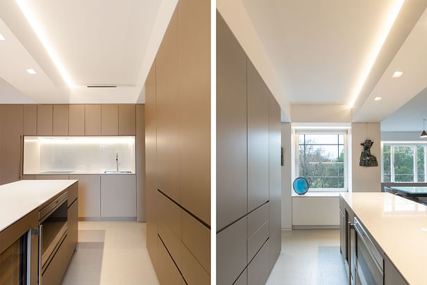 The island hides a wine fridge, microwave, and pull-out trash. Opposite the sink wall includes a dishwasher and 24' induction cooktop and wall oven. Recessed finger pulls are used throughout the apartment for a super clean, minimal look without any hardware.