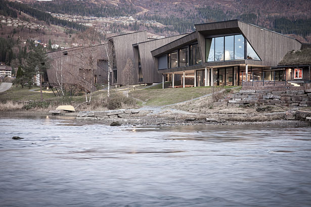 Building seen from opposite riverbank. Photo: Sam Hughes.