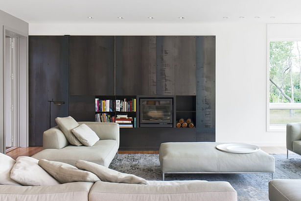 Living Fireplace with Black Steel Surround and Pocket Door