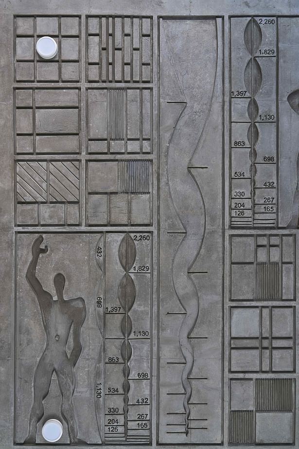 Concrete mural featuring Le Corbusier's Modulor Man