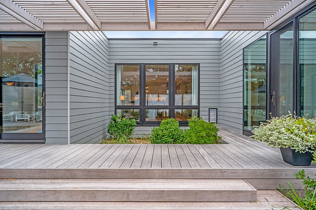 The guest suite is connected to the pool deck with this bridge piece, covered in a cedar slat trellis.