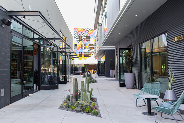 Recalling the structure’s past life, the last vestiges of repurposed automotive bays are juxtaposed with modern appointments, introducing glass storefronts where roll-up garage doors once existed. (Katie Gibbs)