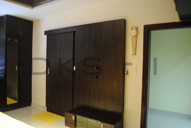 Master bedroom - TV panel with sliding door for rest room