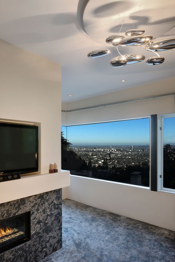 The windowed master bedroom includes a linear gas fireplace with a granite mantle that ties seamlessly with the 100% silk carpeting that mirrors the marbling of the granite. 