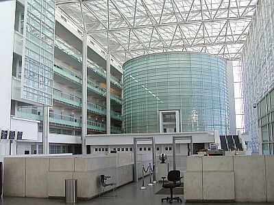 Visitors to the Sandra Day O'Connor Federal Courthouse pass through a very uncourtlike glass enclosed atrium which could aptly be described as a hothouse. The cylindrical glass center point houses a ceremonial courtroom. (Image via http://www.doney.net/aroundaz/phoenix-oconnor.htm)