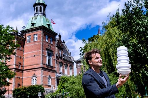 Bjarke Ingels posing with model of H.C. Anderson Hotel on site. Photo by by Bax Lindhardt.
