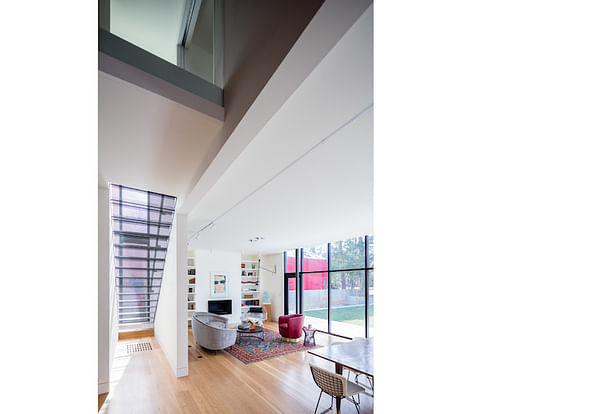 The double-height space that marks the transition from the original house to the new addition.