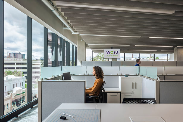 The workspaces feature a clear circulation path and access to light and views for staff.