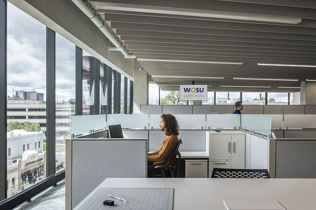 The workspaces feature a clear circulation path and access to light and views for staff.