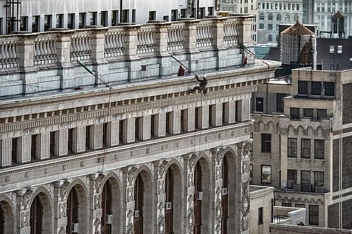 A rope-access building inspector working for Howard L. Zimmerman Architects rappels down the Flatiron Building to survey its historic facade for safety issues. Photo: Jack Kucy, image via @hlzarchitects/<a href="https://www.instagram.com/p/BsyZtiSASjx/">Instagram</a>.
