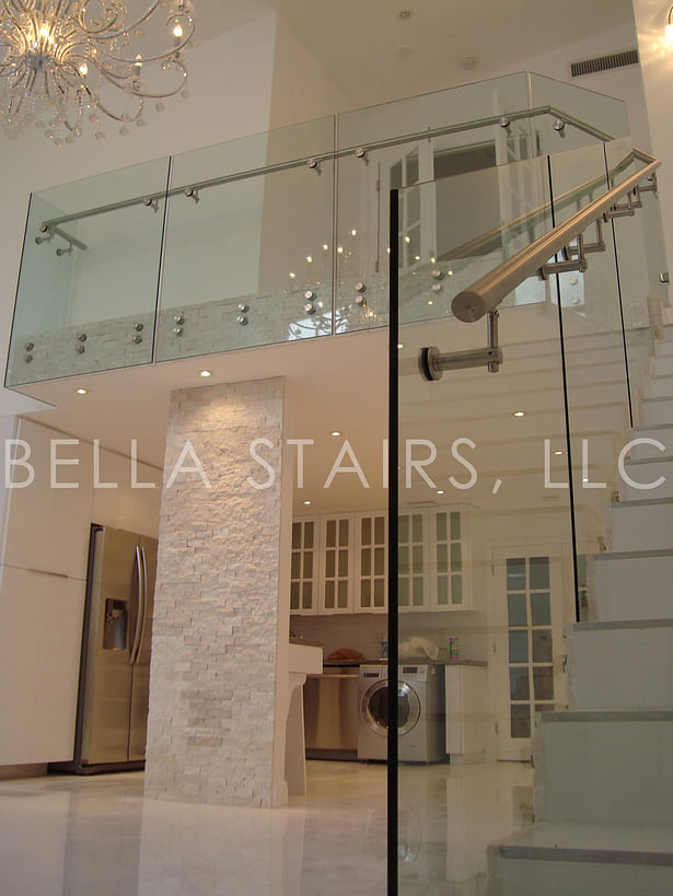 Stainless steel handrail mounted directly onto glass panels