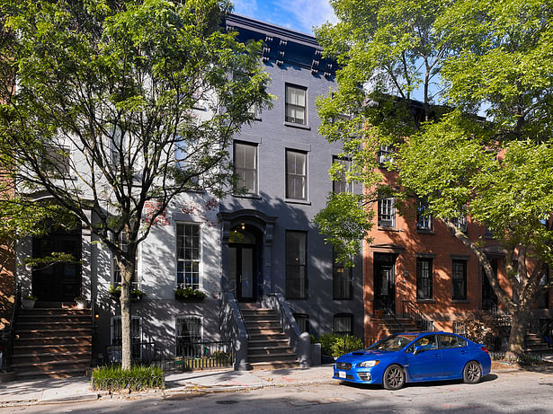 This nine single-room occupancy apartment building was converted into a two-family residence.