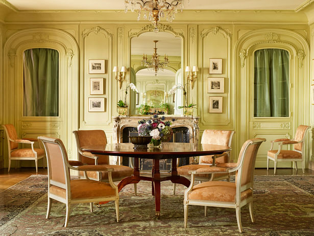 On one side of the music room is an elegant seating group framed by a collection of 20th- century engravings and a large Jasper Johns painting above the sofa. The cocktail table is based upon a Maison Jansen model once owned by the Duke and Duchess of Windsor.