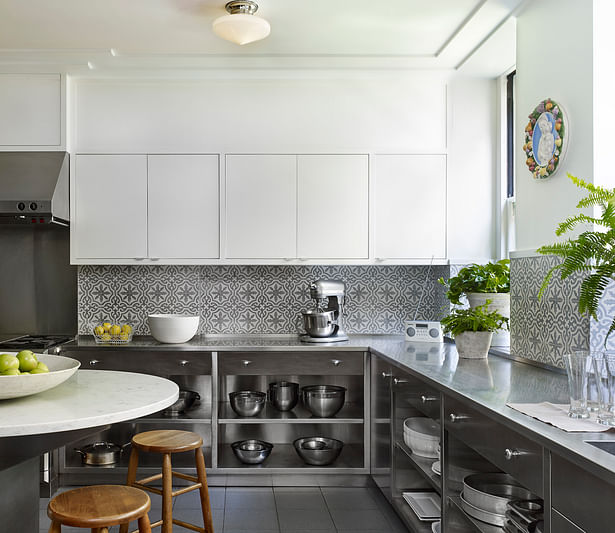 Stainless steel lower cabinets, cement tile backsplash and painted wood upper cabinets
