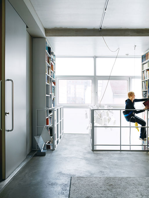 Dulkinys uses the remote-controlled mountaineer’s harness to peruse the two-story bookshelf. Photo by: Pia Ulin