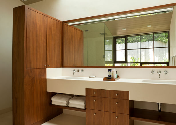 The master bathroom features a custom limestone and walnut vanity. 