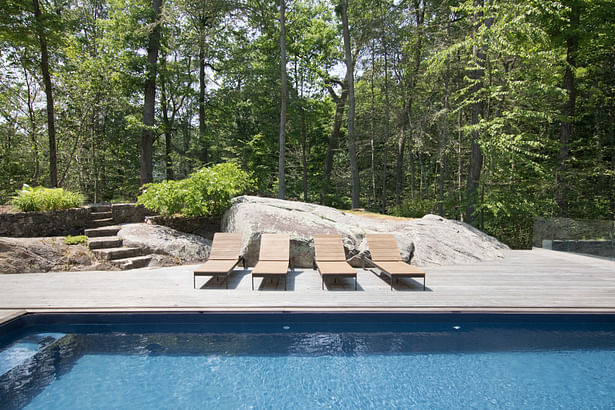 On the rocky site, the pool deck is built right into existing boulders that project from the earth.