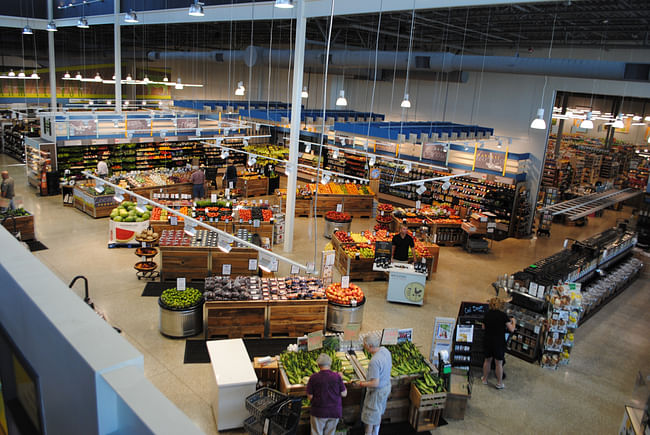 Interior of Harvest Market from the upper mezzanine, where shoppers gather for lunch and board games during the day and glasses of wine at night. (Photo courtesy of Joe Fassler)