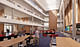 A four-story atrium provides a campus hub and campus connecting passage. Each level features seating and collaborative settings. The oak-lined wall is the intersection of new construction with the prior structure.