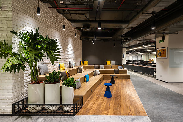 An open, informal seating space designed on a step-like layout by Space Matrix for BrowserStack Mumbai