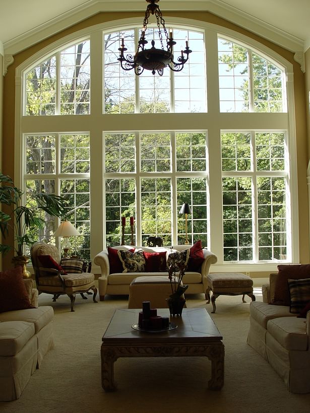 Arched floor-to-ceiling windows in the great room offer beautiful views of the outdoors