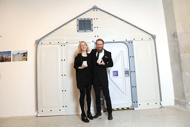 The winners in front of part of their design. Image: Getty Images