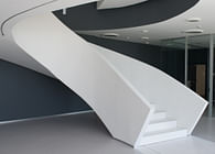 A sculptural staircase in HI-MACS® for a contract project in between architecture and interior design