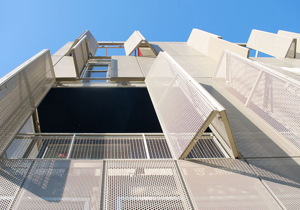 Operable perforated panels at front facade