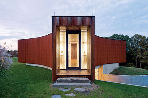 The entryway doubles as a private art gallery, lit in part by one of the house’s three circular skylights. Below sits the property’s garage. (Photo: Iwan Baan)