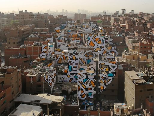 The piece "Perception" by Tunisian-French artist eL Seed spans over numerous brick buildings in Cairo's neglected Manshiyat Naser neighborhood. (Photo: eL Seed; Image via techinsider.io)