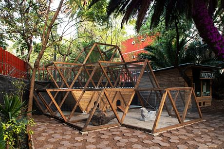 A chicken coop built from salvaged construction waste inspired by Mayan pyramid culture inside a community garden in Mexico City.