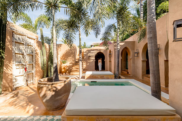 The Moroccan style is reflected in the archways and concrete color