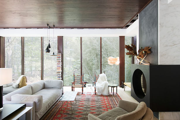 The glass-wrapped living room, which cantilevers over a small stream, was restored, including the original wood ceilings and the circular fireplace surround. New energy-efficient glazing replaced the existing.