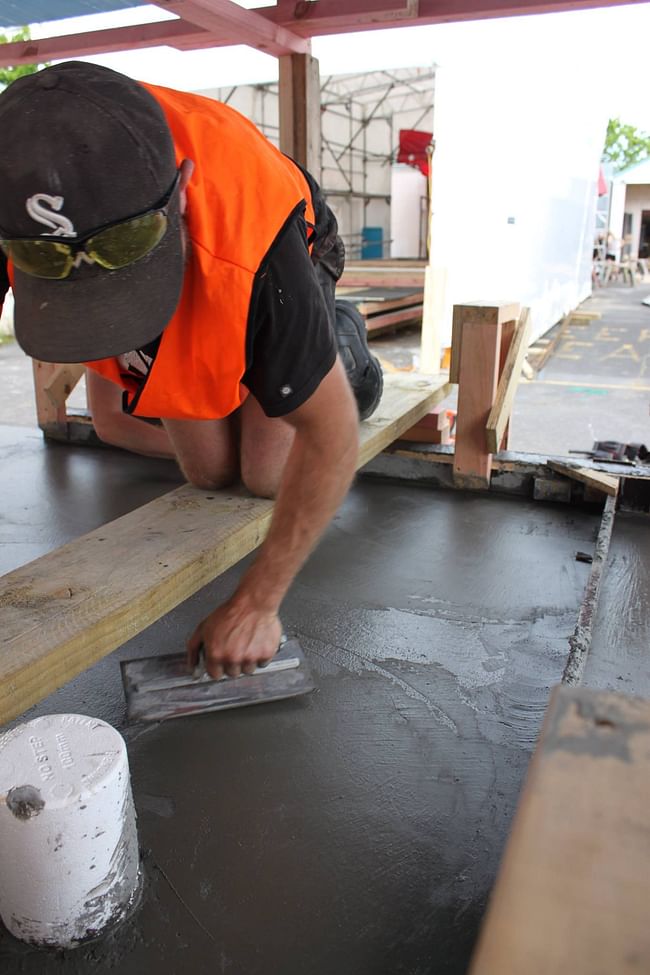 James smoothing the surface of the concrete