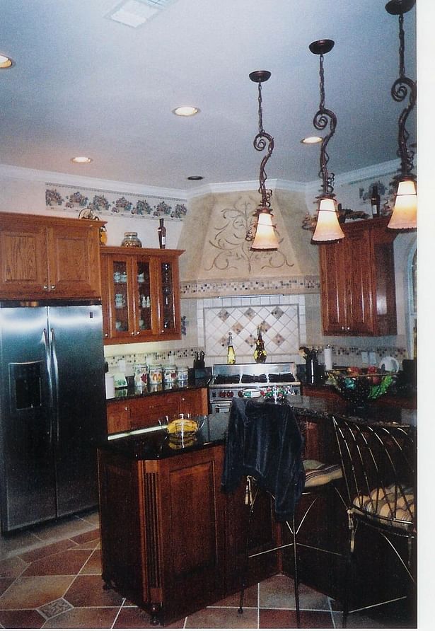 After-New vent hood and utilized cabinets from butler's pantry between refrigerator and range.