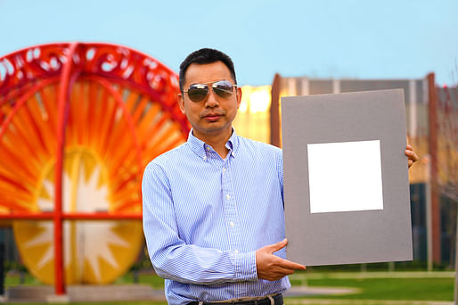 Xiulin Ruan, a Purdue University professor of mechanical engineering, holds up a sample of what his lab claims is the whitest paint on record. Credit: Purdue University/Jared Pike.
