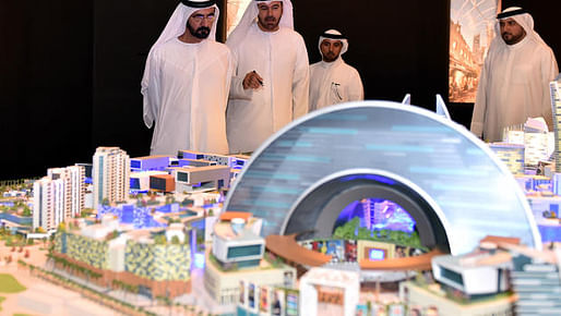 In this Saturday July 5, 2014, photo released by the Dubai Government Media Office, UAE Prime Minister and Dubai ruler Sheik Mohammed bin Rashid Al Maktoum, left, listens to Mohammed Abdullah Al Gergawi, center, chairman of Dubai Holding, during a presentation on the planned Mall of the World...