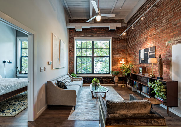 Units boast beautifully restored brick, rich hardwood floors, and soft LED lighting. New energy efficient windows create a comfortable, naturally lit living space. © Christian Phillips Photography