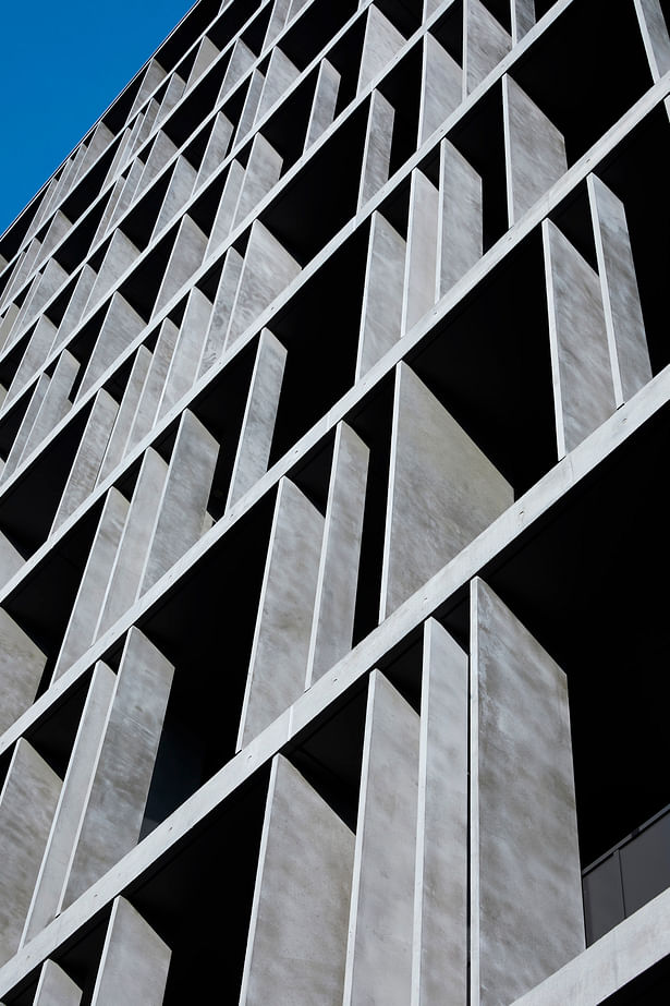 The vertical concrete panels have been added to the façade randomly