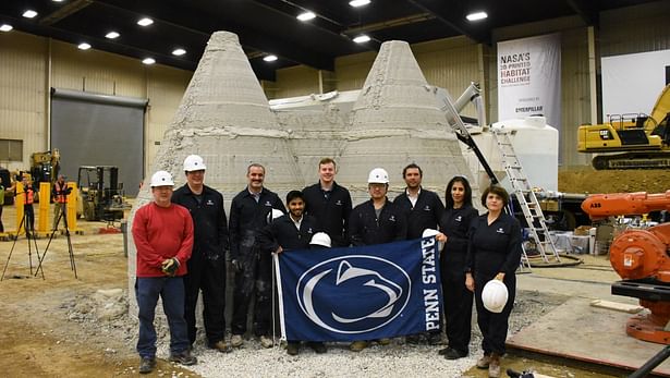 Members of the Penn State team pose in front of the first fully enclosed 3D-printed housing structure at NASA's 3D-Printed Mars Habitat Challenge in Peoria, Illinois. Credit: Penn State. Creative Commons