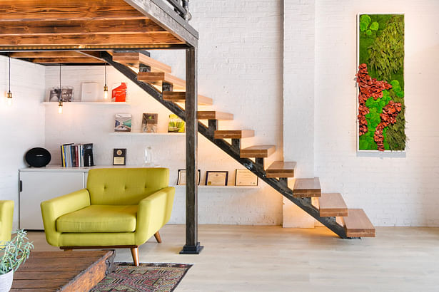 Original brick, painted white. Raw metal floating stairs with handcrafted intuitive pattern manufactured by local artists. More green, more fun.